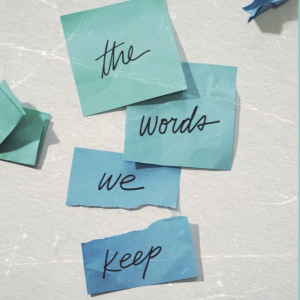 Book cover, sticky notes with the text "the words we keep"
